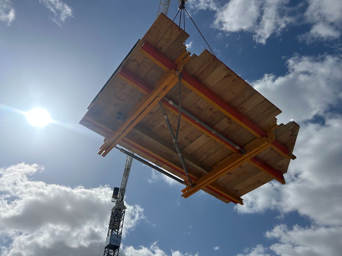 Formwork table panel being lifted into place