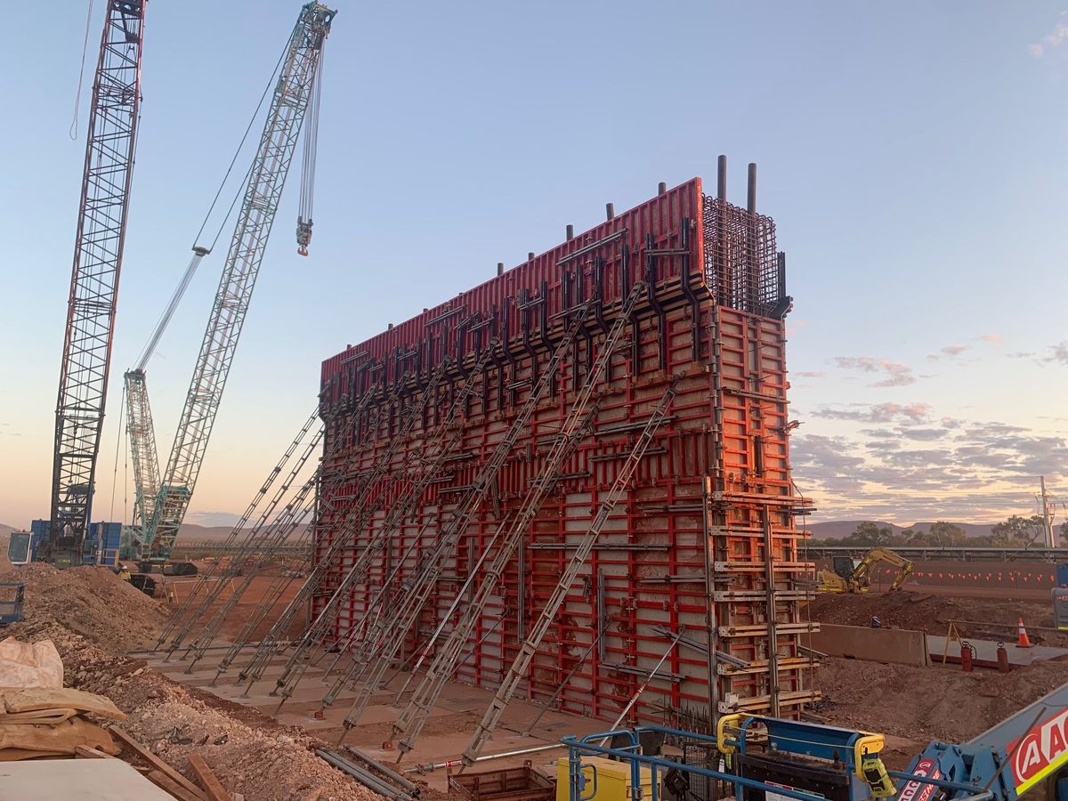 Large-format wall formwork on a regional civil site at sunset
